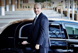 RDV Limousine chauffeur opens door for client