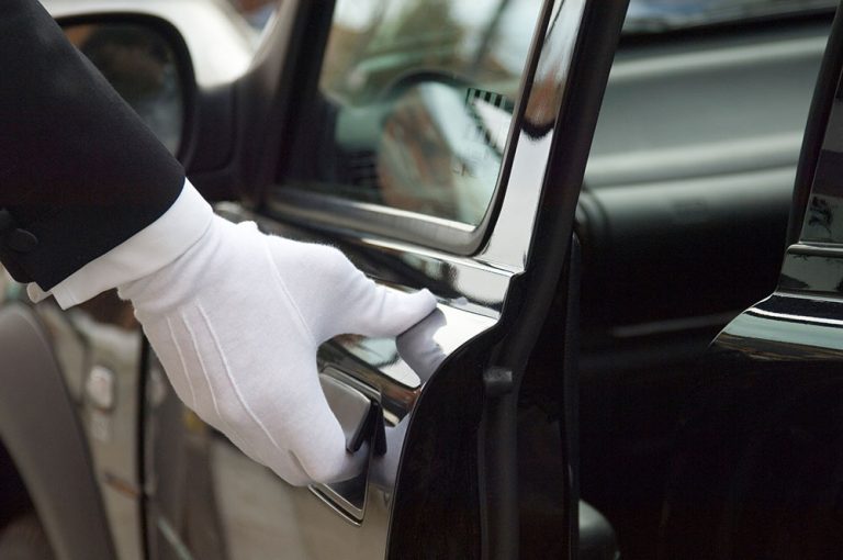 Chauffeur's white glove opening the limo door