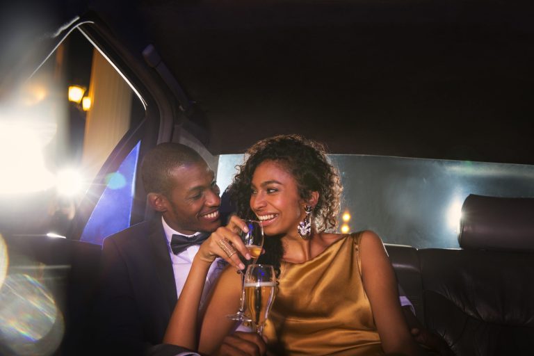 young couple having champagne in a limo
