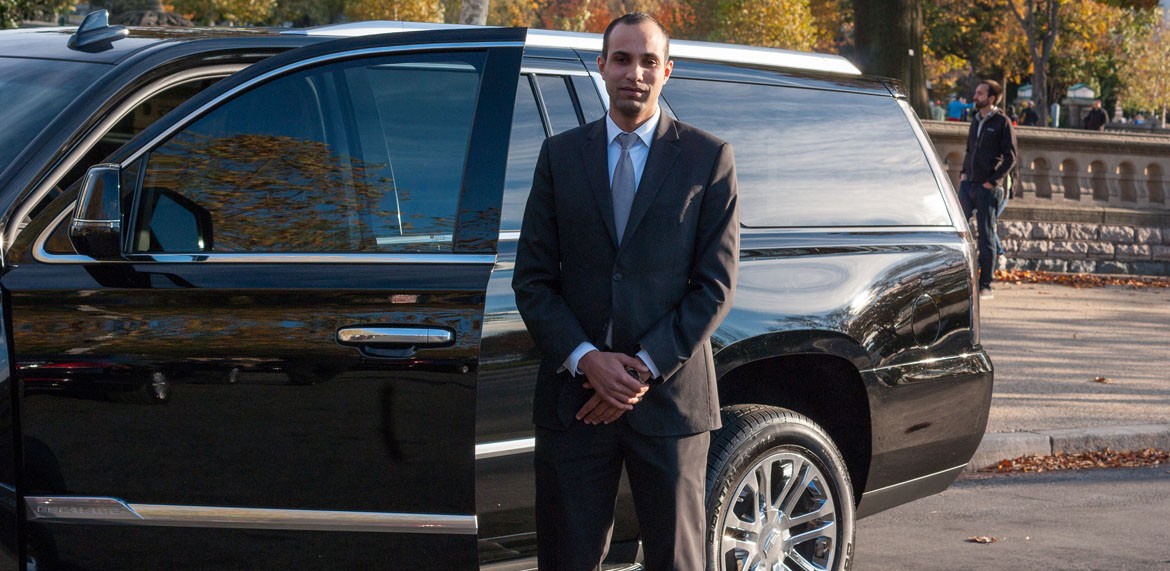 RDV chauffeur standing beside a black Cadillac Escalade in Washington DC