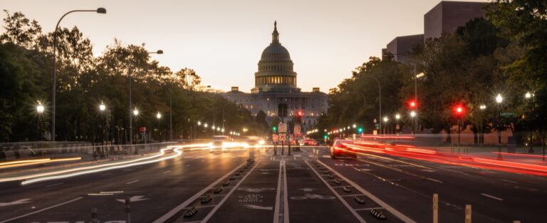 early morning traffic on a Washington DC street with the Capitol building in view