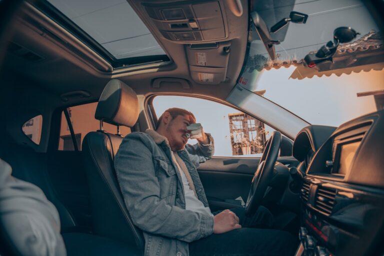 Limo driver resting in car interior illustrating professional etiquette and conduct expectations
