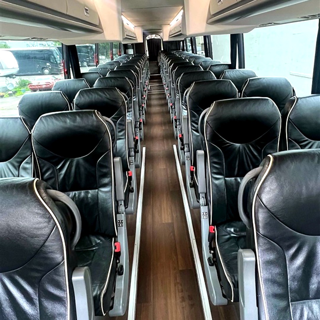 Interior of RDV Limousine 56-passenger executive coach bus with black leather reclining seats