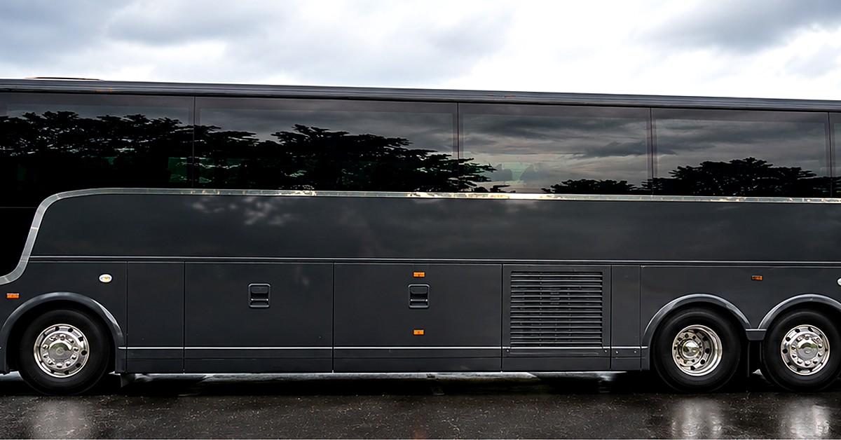 Side view of black 56-passenger charter coach bus from RDV Limousine, corporate group transportation DC area