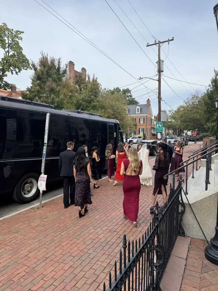 RDV Limousine black party bus picking up a wedding party in Old Town Alexandria, VA