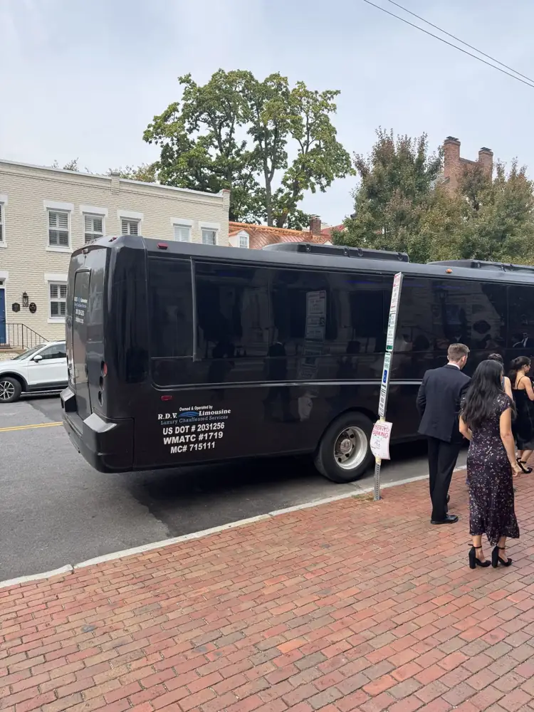 RDV Limousine party bus with US DOT and WMATC numbers waiting for wedding guests in Alexandria, VA